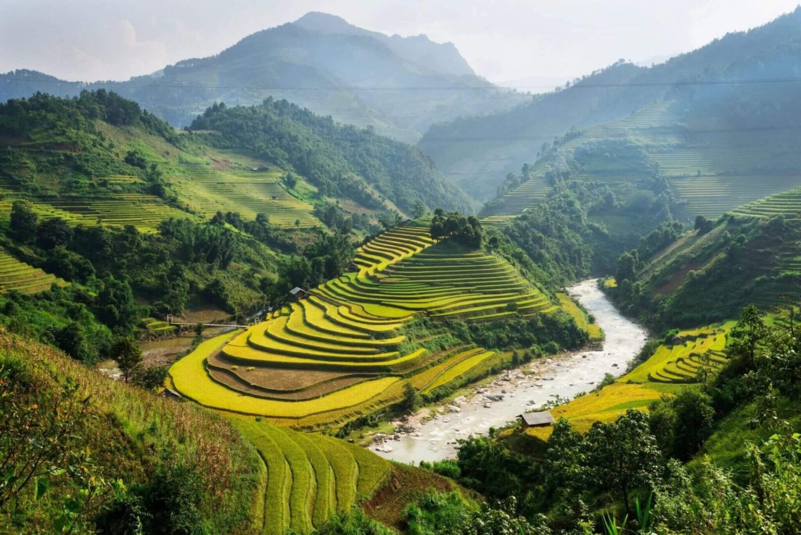 A river running through the middle of a green valley.