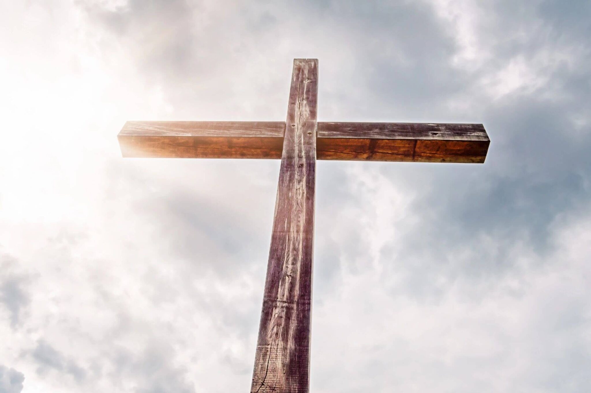 A cross is shown against the sky.